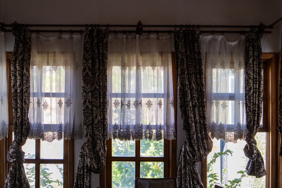 Elegant sheer custom window drapes framing a large window